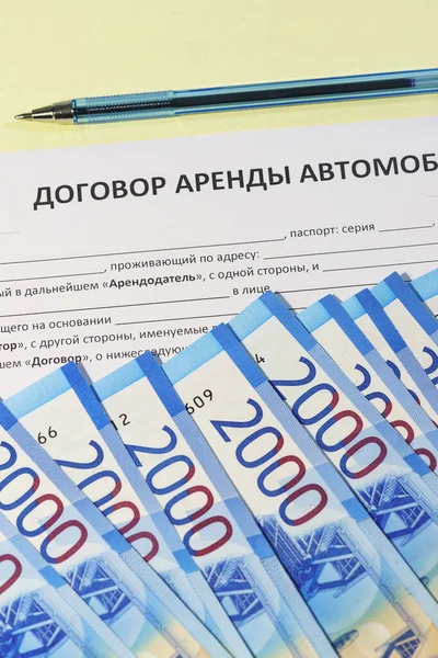 Signing a car rental agreement. Russian rubles and the text 