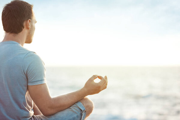 man in meditation near the sea