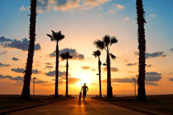 man with skateboard in sunset