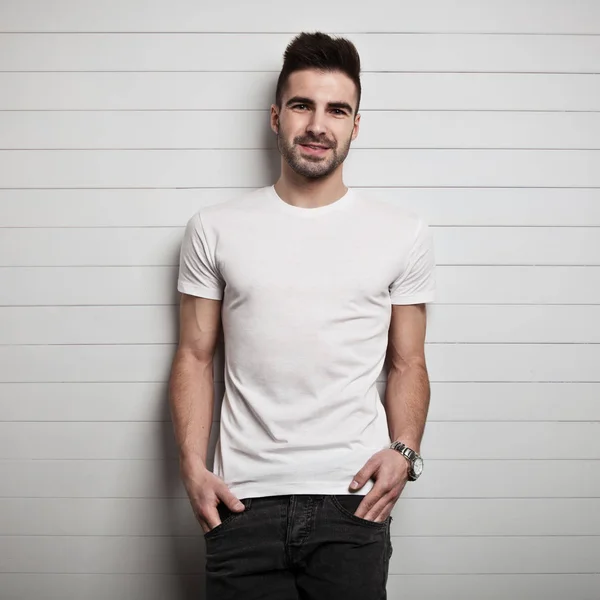 Uomo in t-shirt bianca, fondo parete in legno — Foto Stock