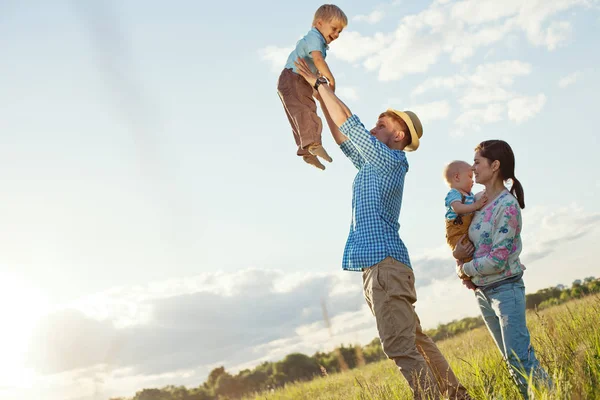 Happy family playing with children in nature — Stock Photo, Image