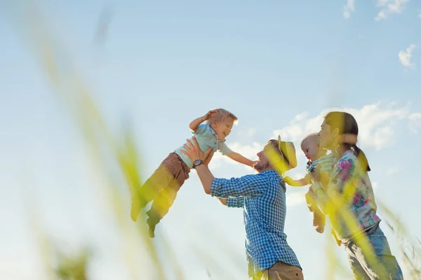 Happy family playing outdoors in the park with children — Stock Photo, Image