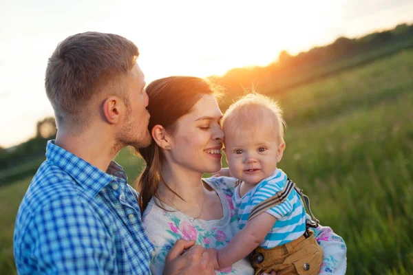 Happy young family with baby spending time outdoors — Stock Photo, Image