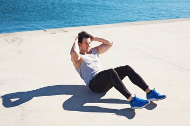 Yakışıklı sporcu karın egzersizleri yapıyor