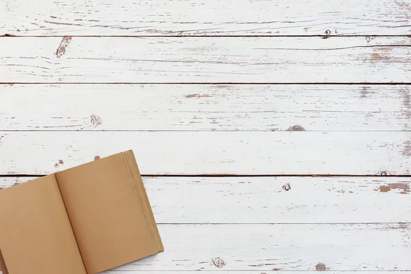 White wooden table with craft grunge notebook, top view — Stock Photo, Image