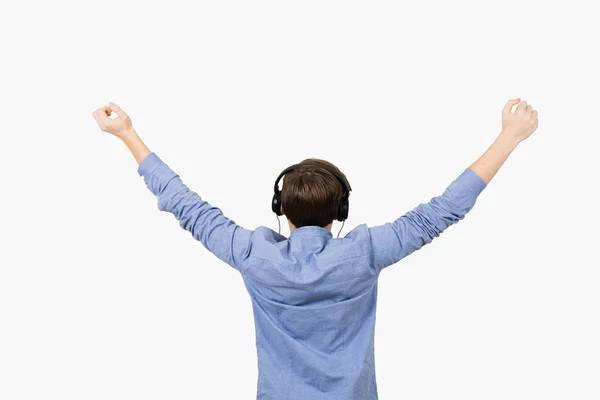 Happy student listening to music with arms raised in air over wh — Stock Photo, Image