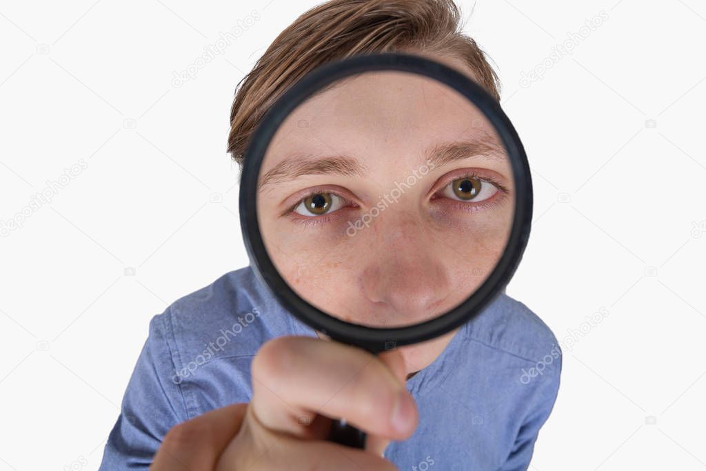 Stressed student looking through a magnifying glass. Difficult t
