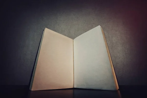 白い空白のページで、テーブルの上で開いている本を閉じます。旧 — ストック写真