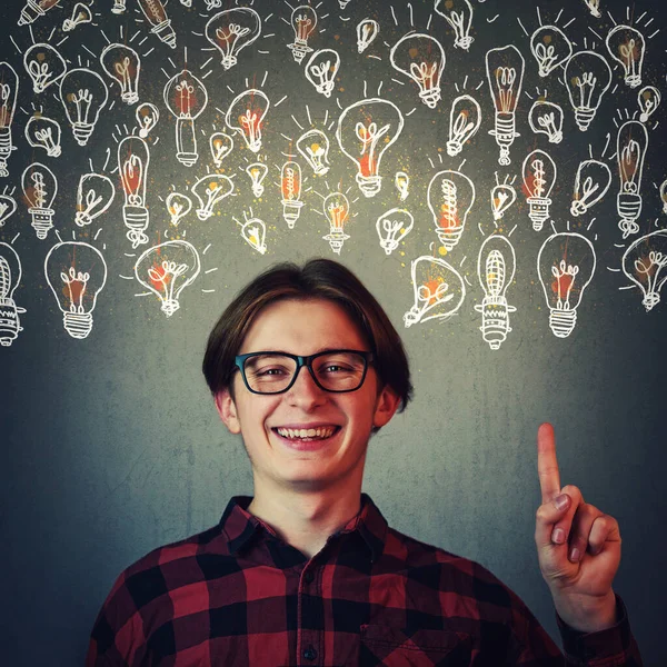 Joyful Guy Pointing Index Finger Showing Multiple Light Bulbs Creative — Stock Photo, Image