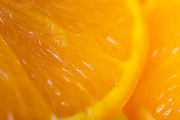 Close-up of  fresh orange slice over orange background. Bio and healthy food.