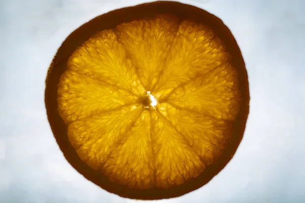 Close-up of  fresh orange slice over orange background. Bio and healthy food.