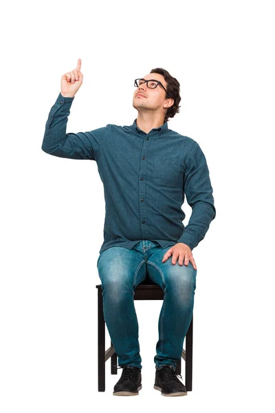 Spokojený Obchodník Sedící Židli Ukazující Ukazováčkem Spokojeně Vzhlížející Izolovaný Bílém — Stock fotografie
