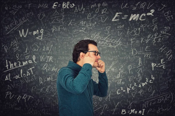 Student guy exhausted of constant learning feels headache, can\'t focus his mind on studying. Man suffers head pain, mental health problems after solving different science formulas and equations.