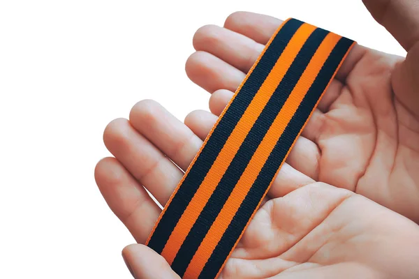 orange and black striped ribbon symbol on May 9 in hands