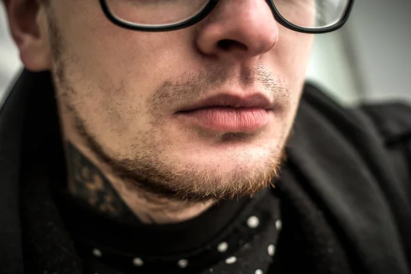 Part of Face of the YOung Man in glasses with focus on lips