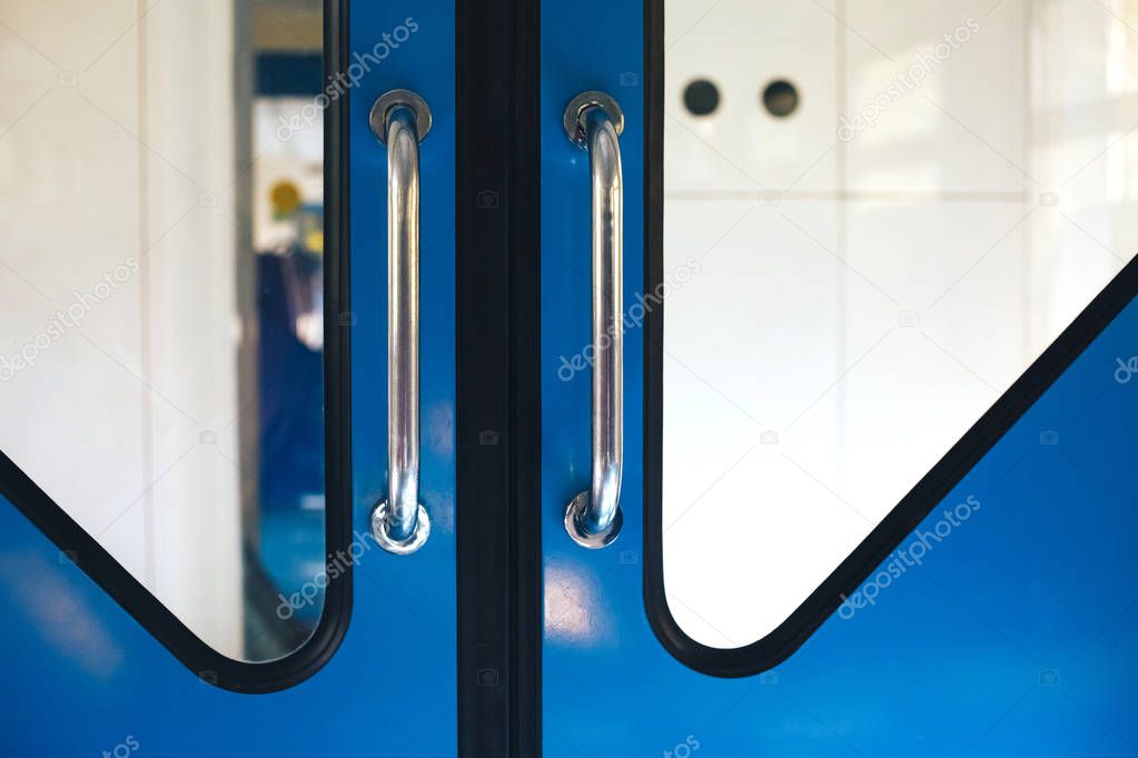 Metallic blue doors in the train between the cars copy space