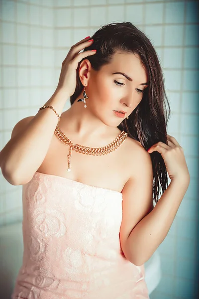 Spa-woman with jewelry. Beautiful girl after bath. Perfect skin. Skin care. The concept even in the shower not to part with your favorite jewelry