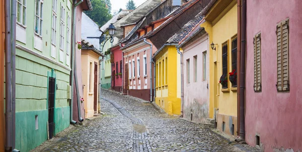 Rua velha com casas coloridas em Sighisoara cidade medieval, Roménia — Fotografia de Stock