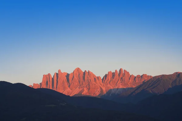 red mountain at sunset. Dolomites landscape in Val di Funes, Italy
