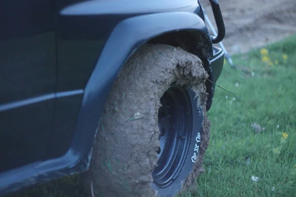 off road car tire full of mud