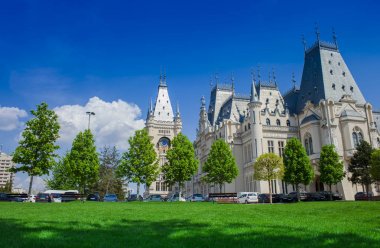 the Palace of Culture in Iasi city, Romania. green park and blue sky background clipart