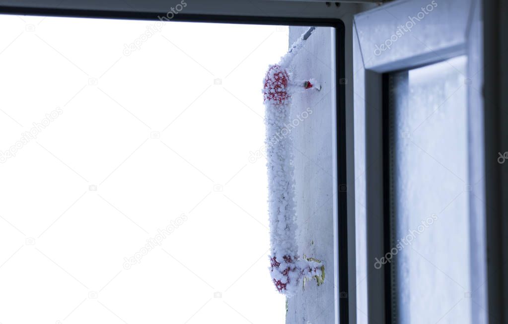 ice frost thermometer with frozen sub zero temperature on the window