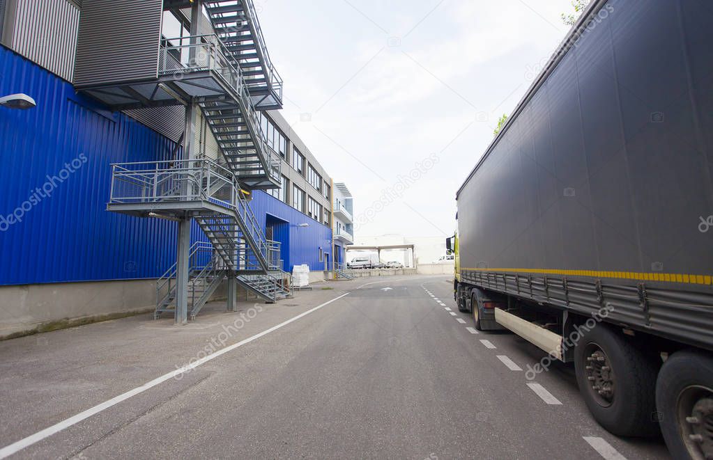 red truck discharging goods in warehouse. transportation concept