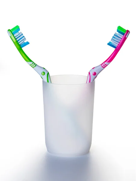 Two toothbrushes in a glass — Stock Photo, Image