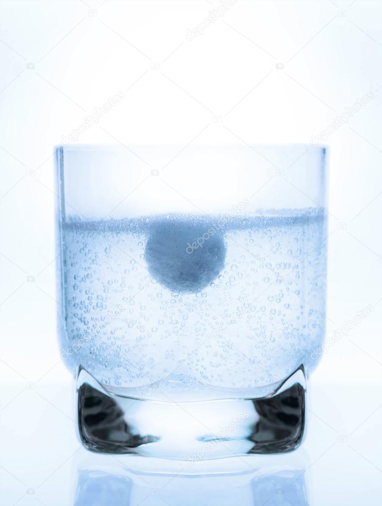 aspirin tablet in a glass of water