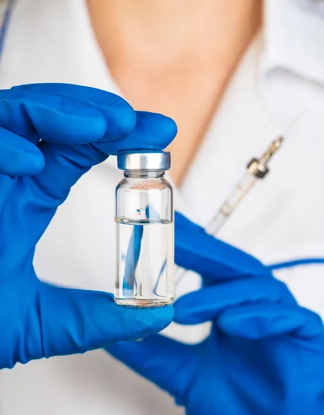 Doctor is holding glass bottle — Stock Photo, Image