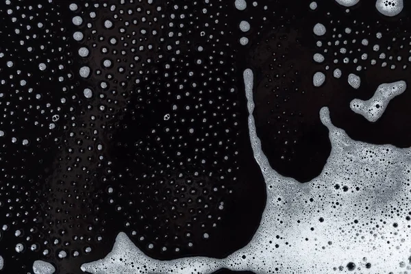 Zeep schuim textuur op zwart — Stockfoto