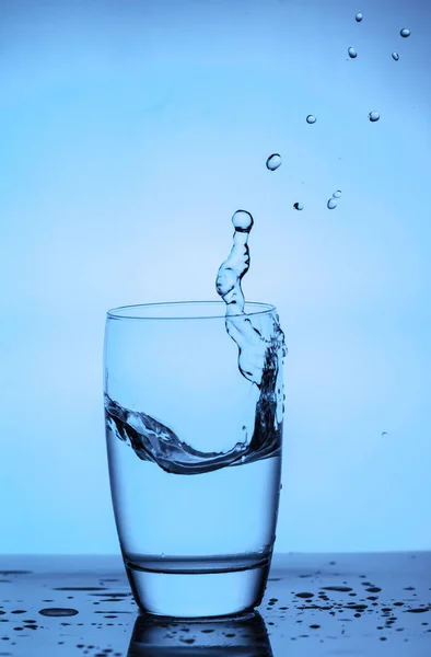 Water splashing out of a glass — Stock Photo, Image