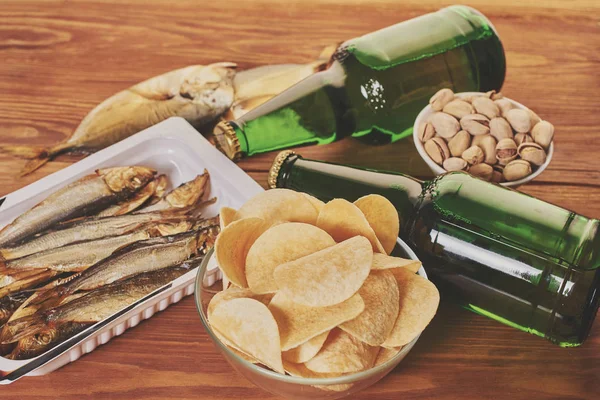 Beer in bottles with snack — Stock Photo, Image