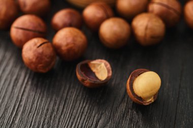 Siyah ahşap arka planda Macadam fındığı yakın plan                               