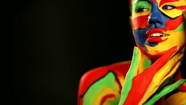 Woman with color face art and body paint. Colorful portrait of the girl with bright make-up and bodyart. Slowmotion. — 비디오