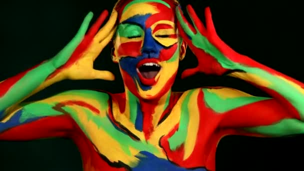 Woman with color face art and body paint. Colorful portrait of the girl with bright make-up and bodyart. — 비디오