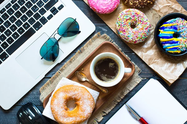 Donuts, Laptop, eine Tasse mit Köchen — Stockfoto