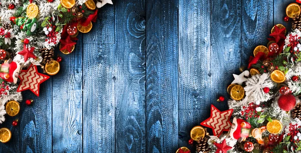 Merry Christmas Frame met groene pijnbomen, kleurrijke kerstballen en houten achtergrond — Stockfoto