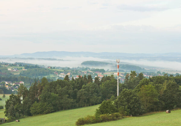 Meadow with transmitter in morning fog, Czech landscape