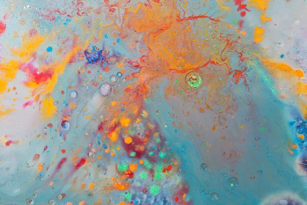 Abstract orange, red and green color mix in milk and oil