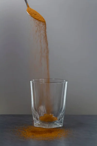 Coffee Falling Spoon Empty Glass Stone Desk — Stock Photo, Image
