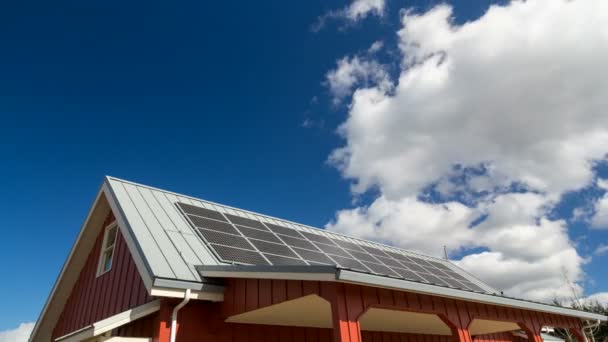 Ultra high definition 4k time lapse movie of moving white clouds and blue sky over rooftop with solar panels installed 4096x2304 uhd — Stock Video