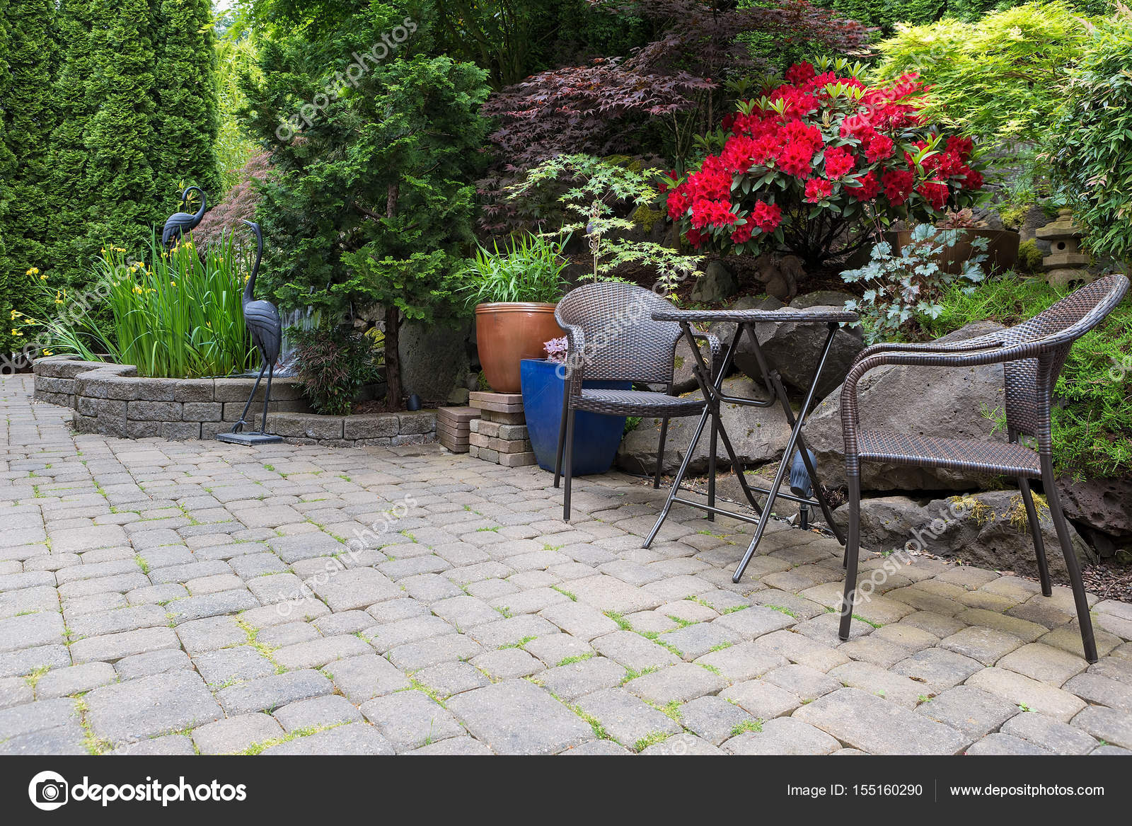 Garden Backyard Pond Landscaping With Bistro Furniture Stock Photo
