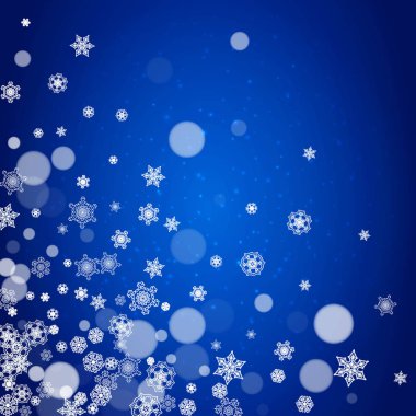 Mavi arka plan üzerinde yeni yıl kar taneleri