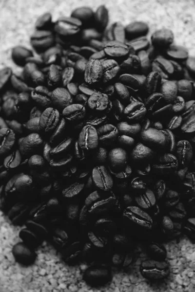 Brown coffee beans close up on black background