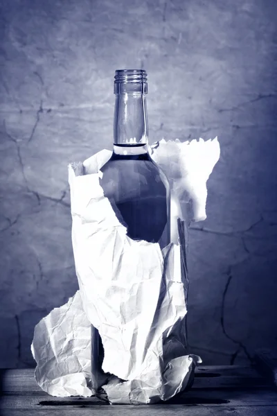 Bottle of hard liquer in the paper bag — Stock Photo, Image