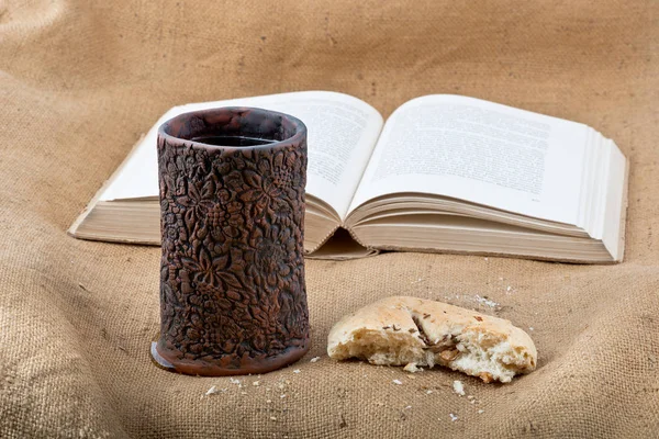 Bible, Chalice And Bread on the Textile Tablecloth.