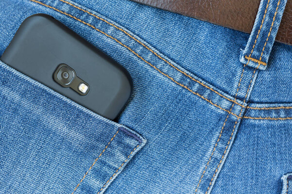 Mobile smart phone in jeans pocket. 