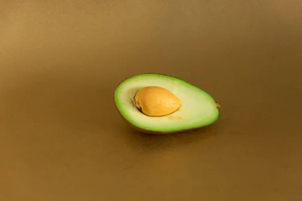 Golden Avocado Cut Golden Background — Stock Photo, Image