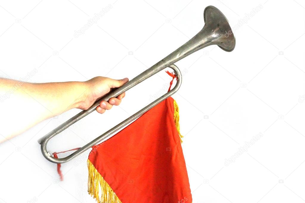 Pioneer Horn horn in hand with red banner on  white background. Soviet horn wind instrument in hand